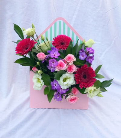 Flower Envelope - A charming envelope arrangement filled with soft pastel tones, vibrant pops of colour, and fresh seasonal textures. Beautifully designed in a keepsake-style presentation box, this delightful gift is perfect for sending love, appreciation, and thoughtful wishes for any occasion.