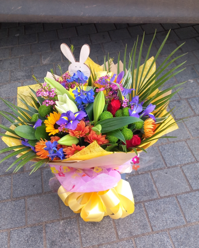 Colour Carnival - A vibrant hand-tied bouquet bursting with joyful seasonal colour, playful textures, and fresh greenery, beautifully wrapped with cheerful finishing touches. Complete with a charming bunny detail, this delightful arrangement is perfect for Easter celebrations, spring gifting, or brightening someone’s day with a fun and festive surprise.