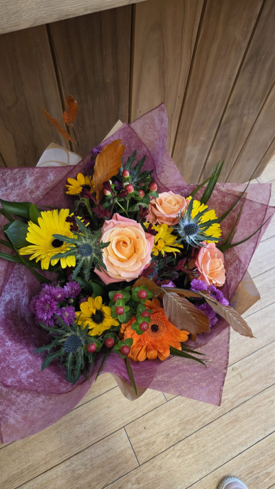 Autumn Glow - A warm and vibrant hand-tied bouquet filled with rich seasonal tones, delicate textures, and fresh foliage, beautifully presented in a stylish gift bag. Combining golden highlights with deep berry shades and natural greenery, this arrangement is perfect for birthdays, thank you gifts, or adding a cheerful touch to any occasion.
