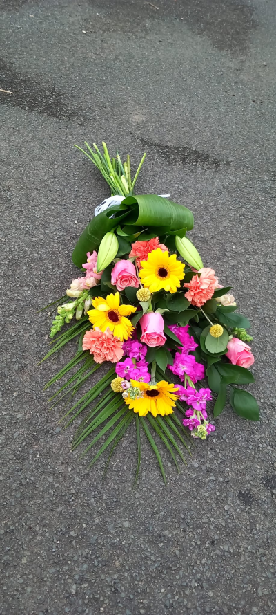 Vibrant Tied Sheaf - A vibrant sympathy bouquet created to celebrate a beautiful life and bring comfort during times of loss. Filled with cheerful seasonal tones, delicate textures, and fresh greenery, this arrangement offers a heartfelt expression of remembrance, love, and support. Elegantly presented for funeral services, memorials, or thoughtful condolence gifting.